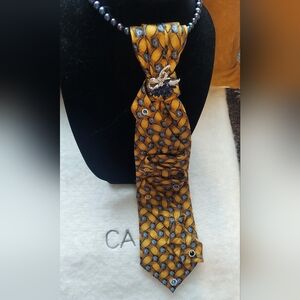 Elegant Blue & Gold Patterned fashionTie with Brooch. Necklace not included.